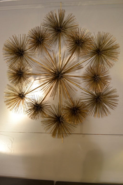 Very dramatic --like a captured firework, this sculpture is made up of multiple, dimensional starburst forms in brass. Signed in ink on center 