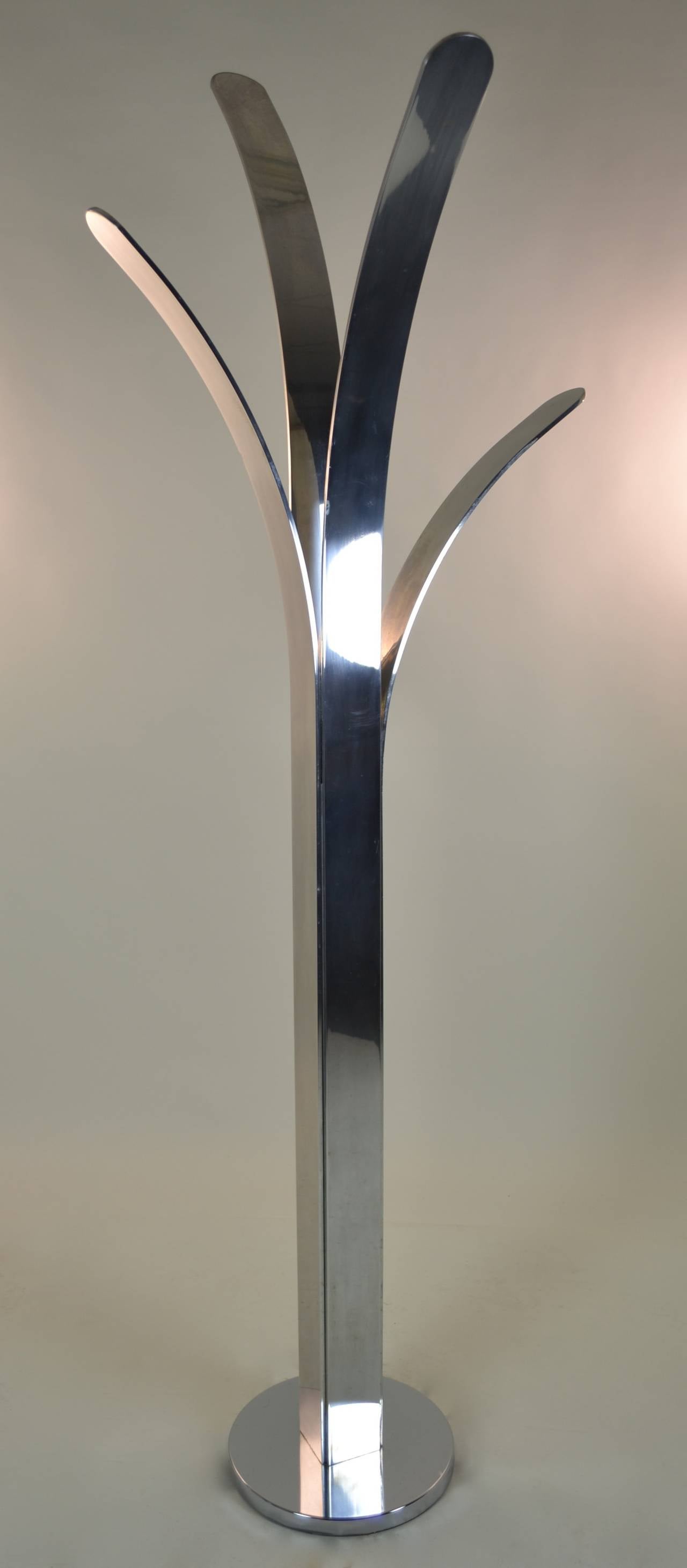 Unusual aluminum sculpture made of heavy sheet aluminum sections --polished and shaped in abstract floral design. Weighted base. Could be used as a coat rack.