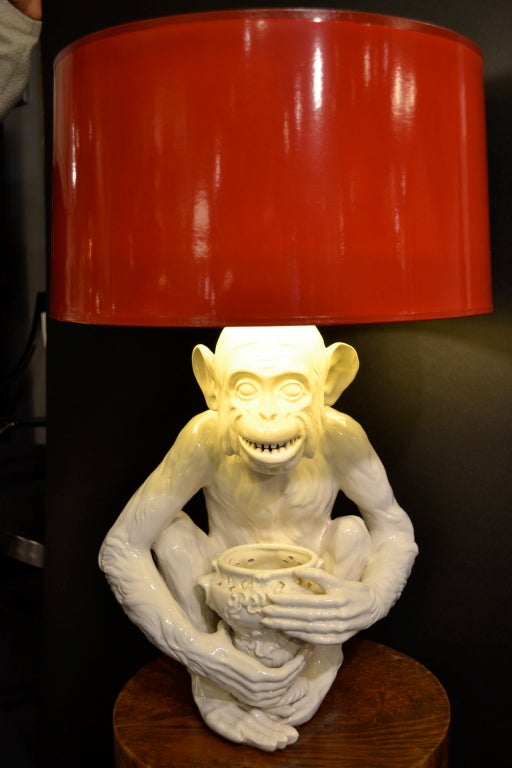 A very finely crafted blanc de chine ceramic monkey as a lamp base. Amazing detail --especially those teeth --and check out the bumps down the spine on the back!  The lamp has been rewired and we have added a red, hand-lacquered shade with gilt