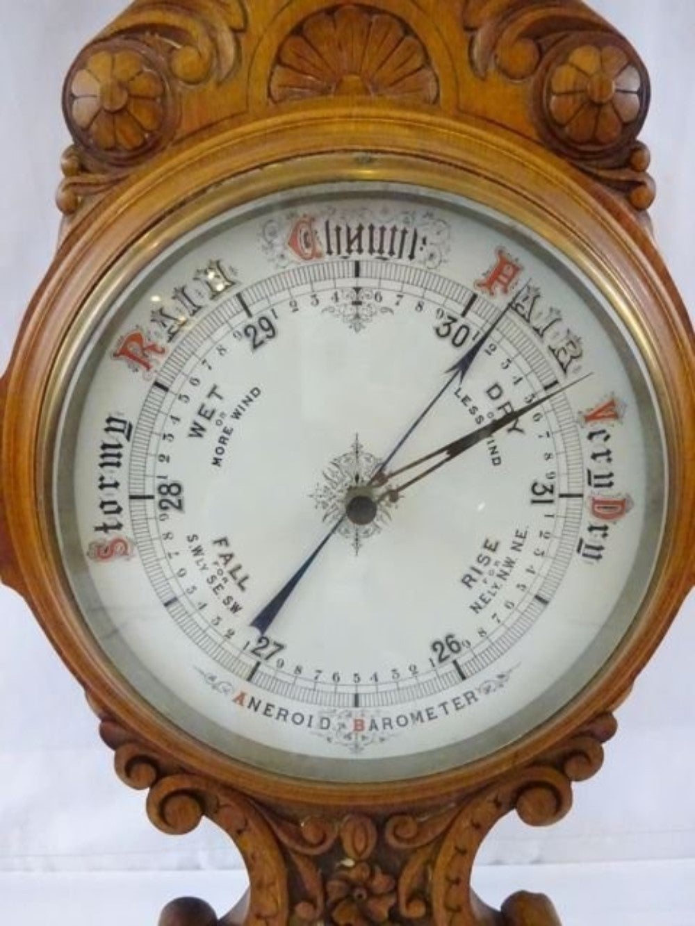 English barometer carved out of oak with original enamel face fronts, Barometer appears to be working but not guaranteed.