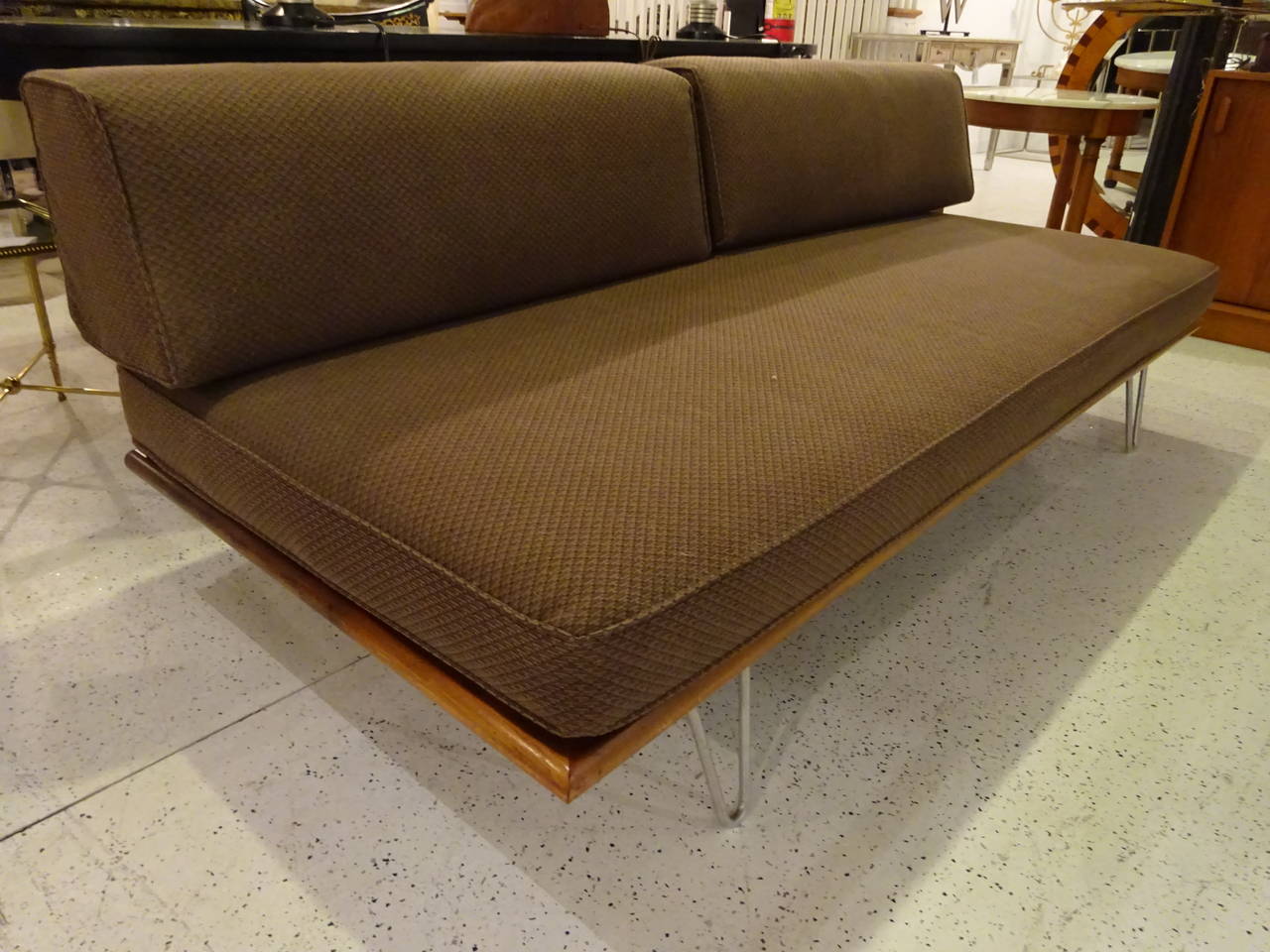 A George Nelson designed day bed with upholstered seat and bolster.