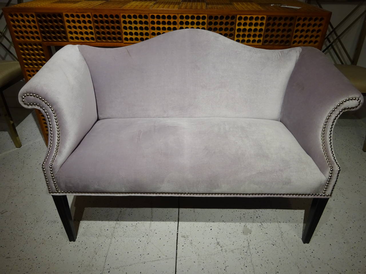 Diminutive Ultrasuede Settee with Polished Nickel Nailheads, raised on four ebonized tapering legs,