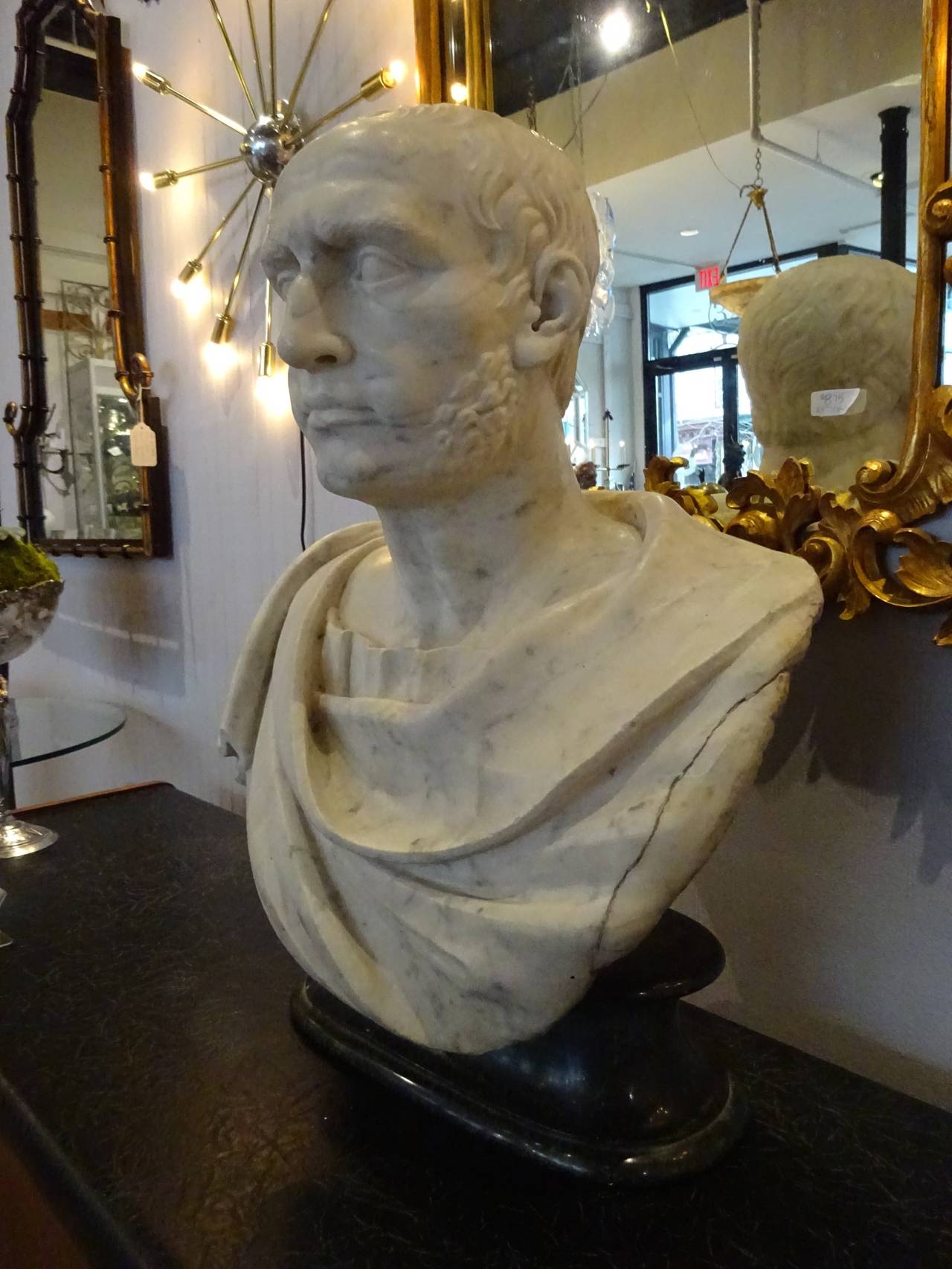 Antique marble portrait bust of Julius Caesar, raised on a later Verdigris oval plinth marble base. Italian, 18th century or older. Well executed portrait bust of the most famous Roman.