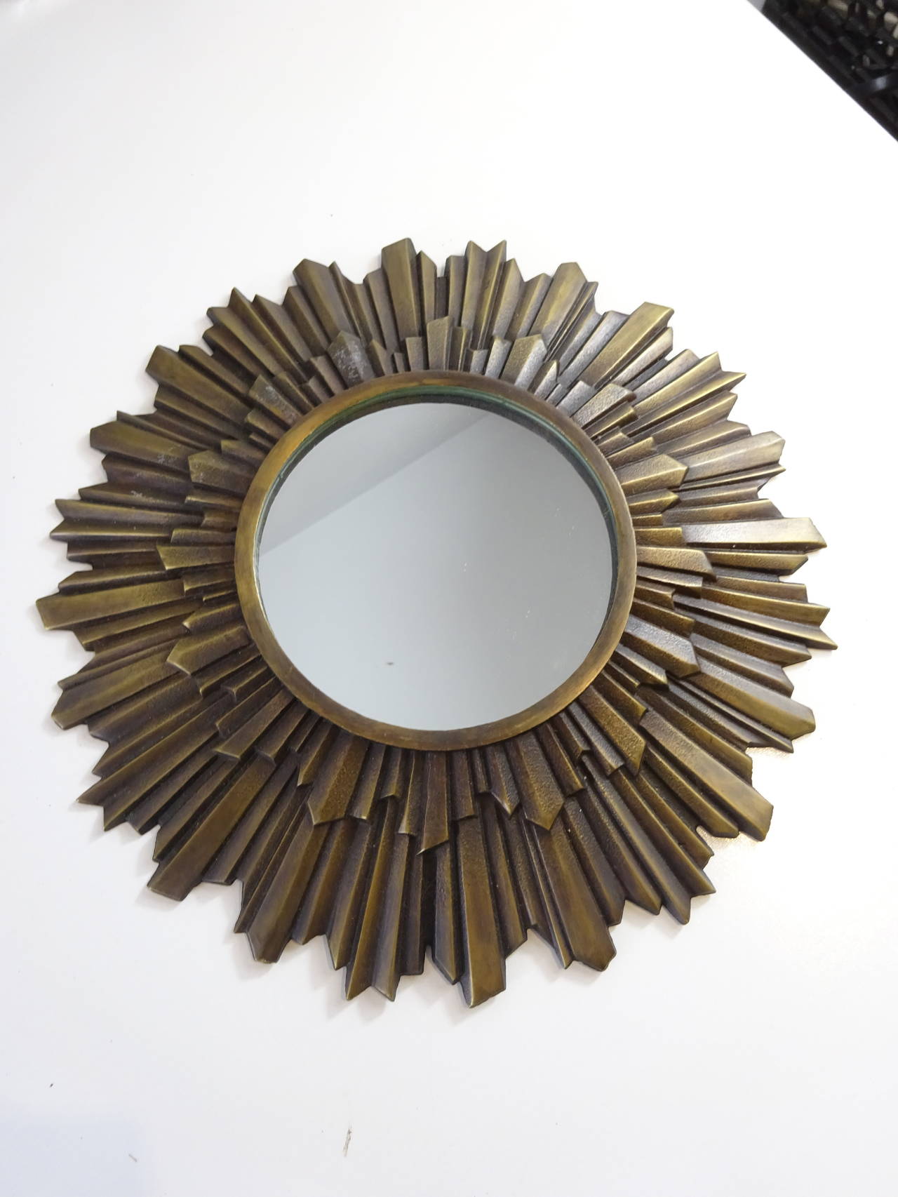 Small bronze starburst mirror, of typical form, finely cast.