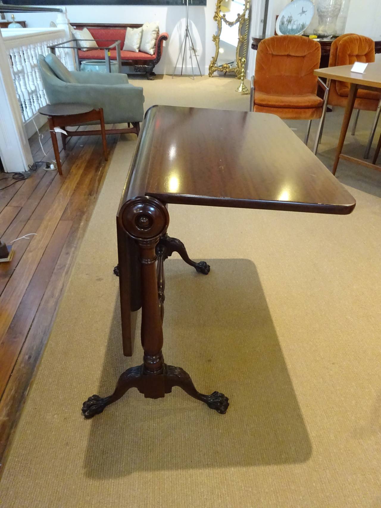 English Napkin Table/ Tuck Away Table,  Of Mahogany with a center cylinder, with two side leaves raised on paw feet