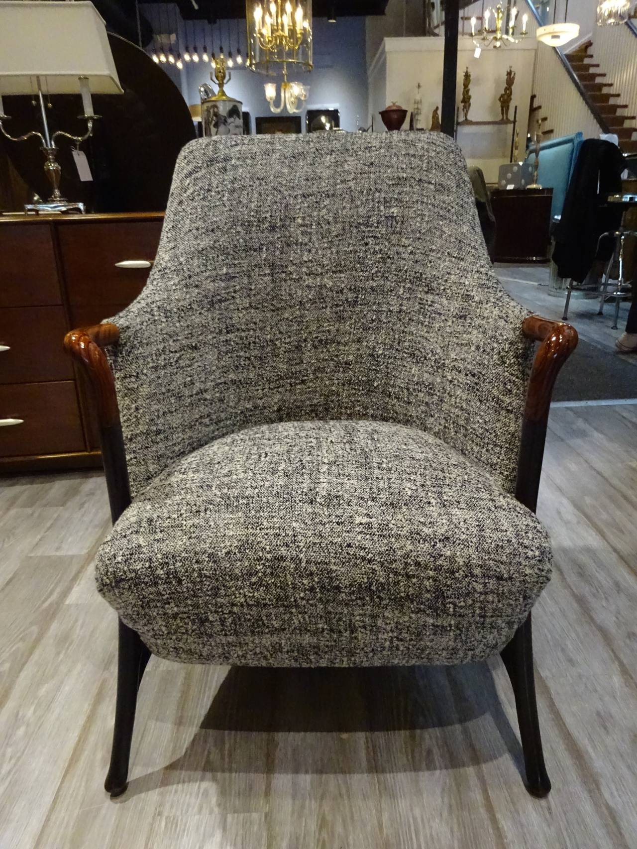 Pair of Mid-Century Italian club chairs, each one with arms of exotic wood and ebonized legs, upholstered in custom black and white fabric.