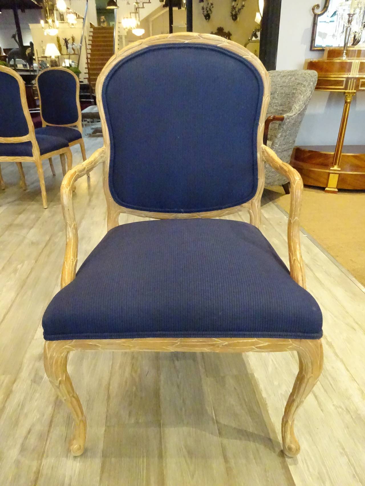 Set of six Serge Roche style faux bois palmate dining chairs, each one of carved beechwood, with blue upholstery.
Armchair measures: 39" H x 20" D x 24" W.
Side chair measures: 19" W x 39" H x 18" D.