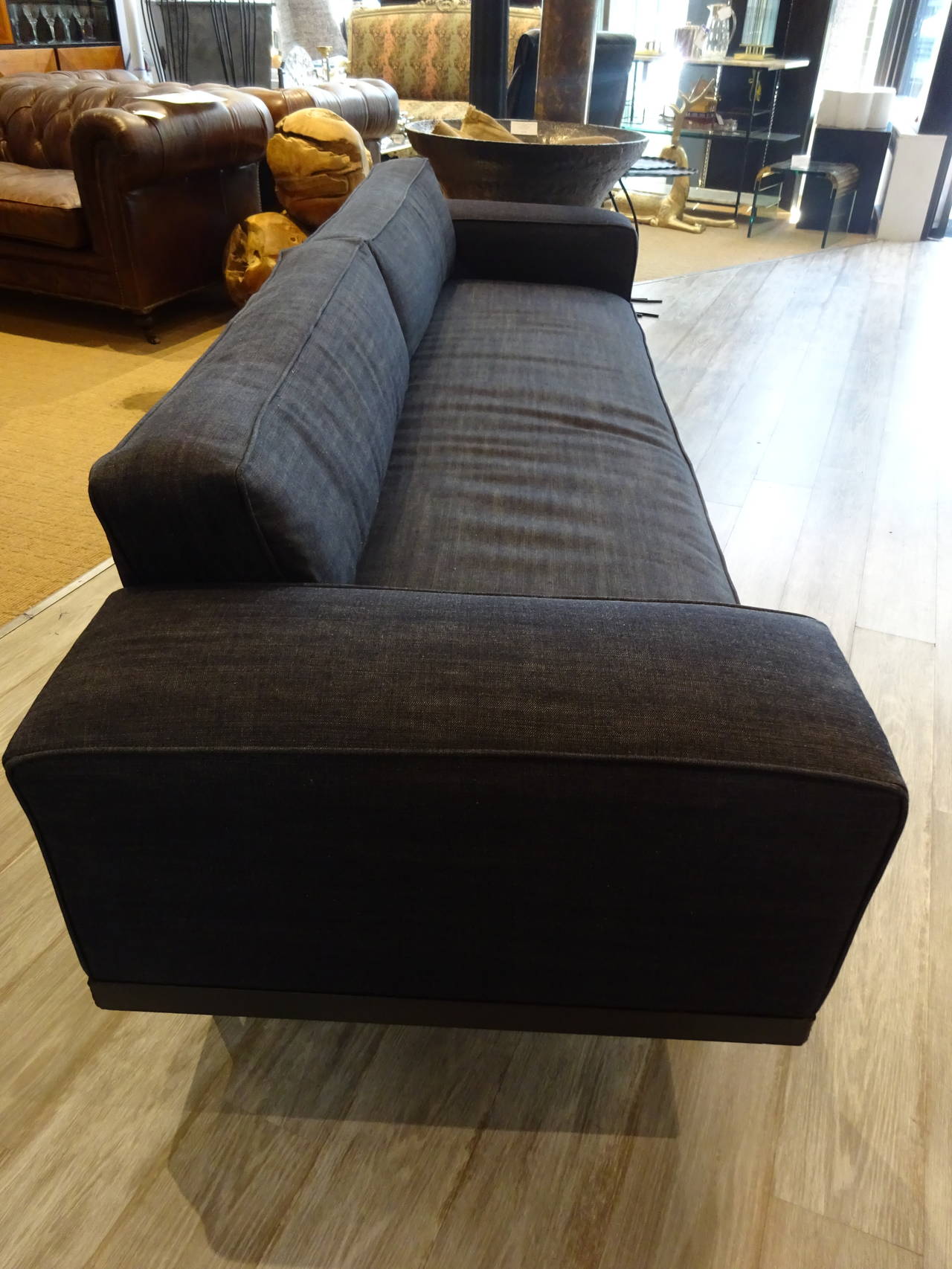Italian Midcentury Sofa, sleek and low profile, raised on rectangular metal frame with four round legs. Upholstered in custom blue denim style fabric