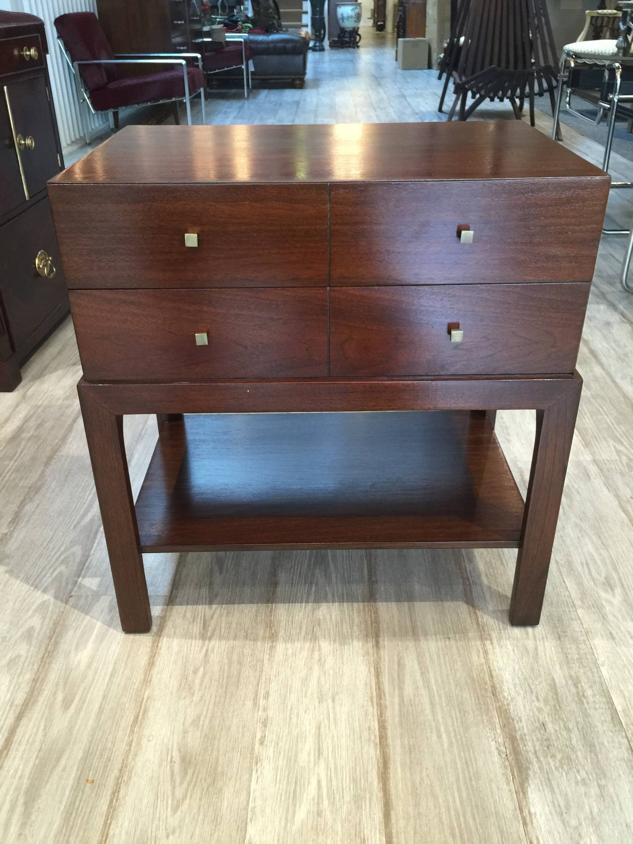 A pair of handsome Parzinger style nightstands by Albert Furniture Company. Rich mahogany and brass knobs.