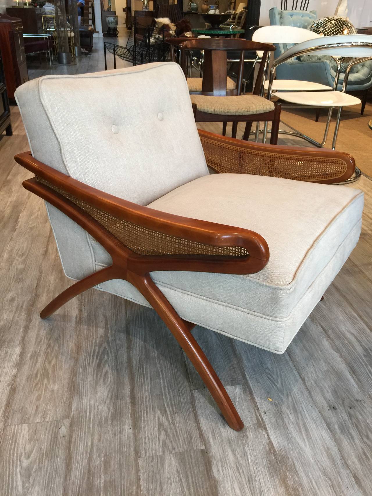 Mid-Century sculptural club chair with rattan detail, recently upholstered.