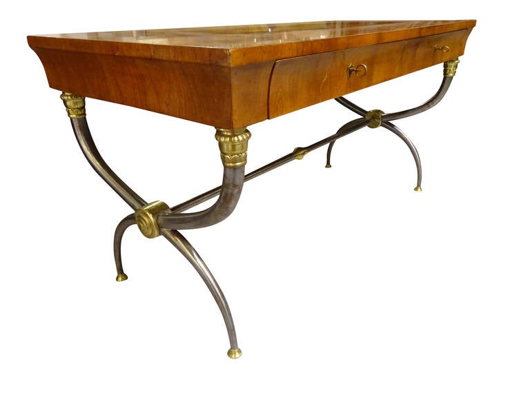 Italian Neoclassic fruitwood campaign style desk with steel and brass base. Top contains two locking drawers.