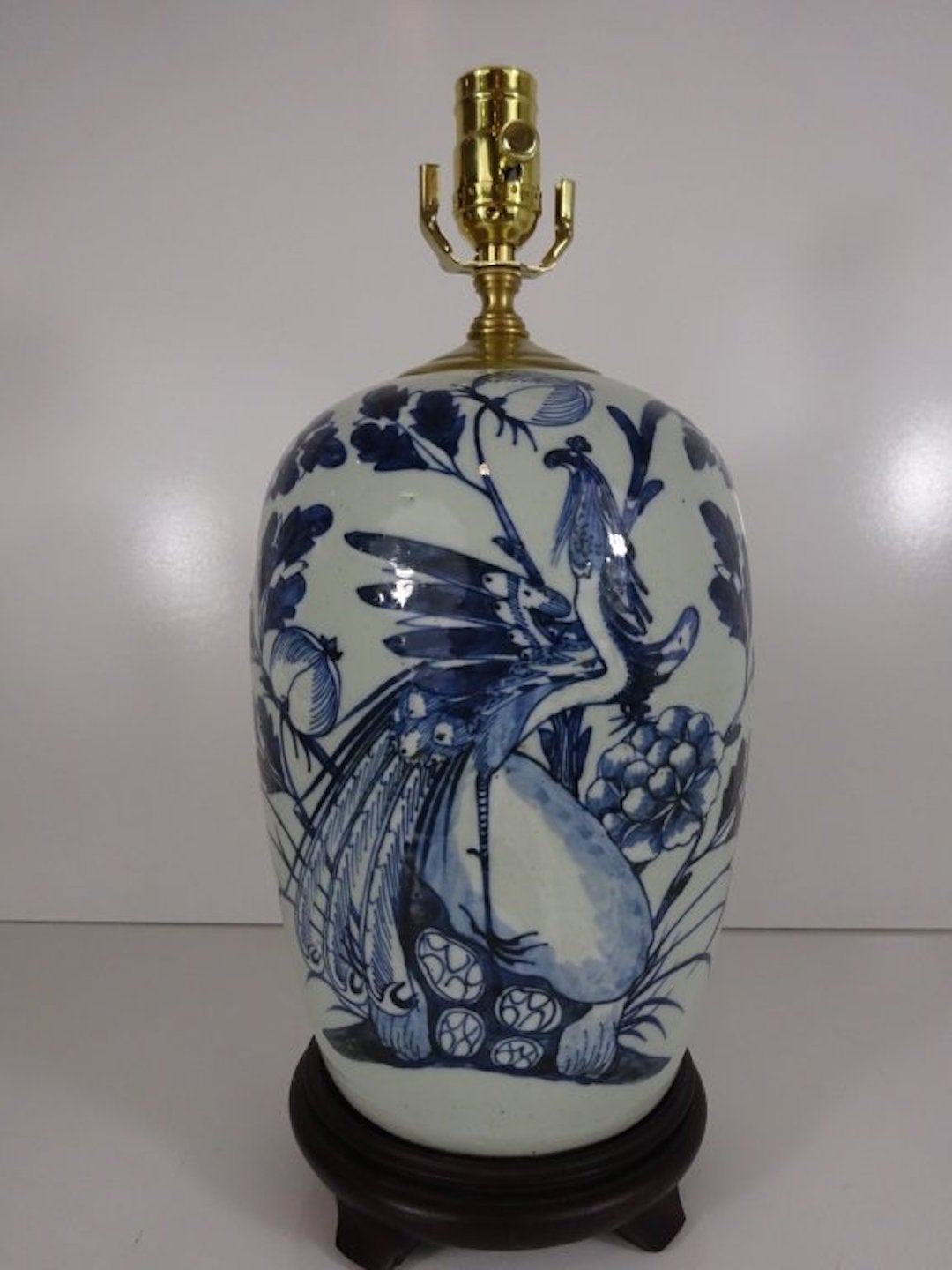 Pair of Chinese Export Blue and White Vases, Now as Lamps. Each one decorated in the Canton style with Bird and floral motif, the backs are not decorated. Each one raised on a carved wood stand, Height to top of Jar is 14