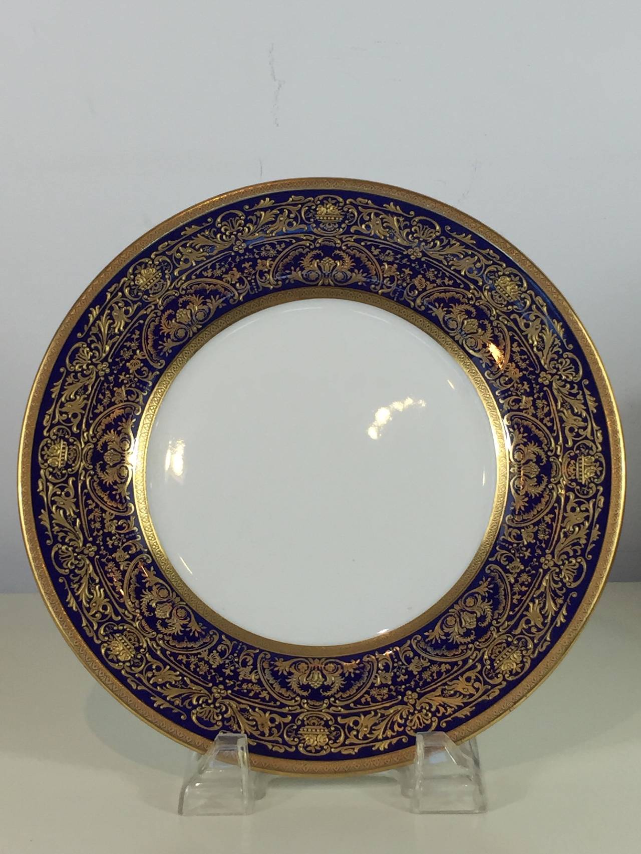 Eight Royal Doulton gilded age dinner plates (1902-1922).
Each one with cobalt blue borders and intricate raised gilt enamel
Gilders mark "HB" for Herbert Betteley.
Green Royal Doulton back stamp 1902-1922.
Retailers mark of:
Davis