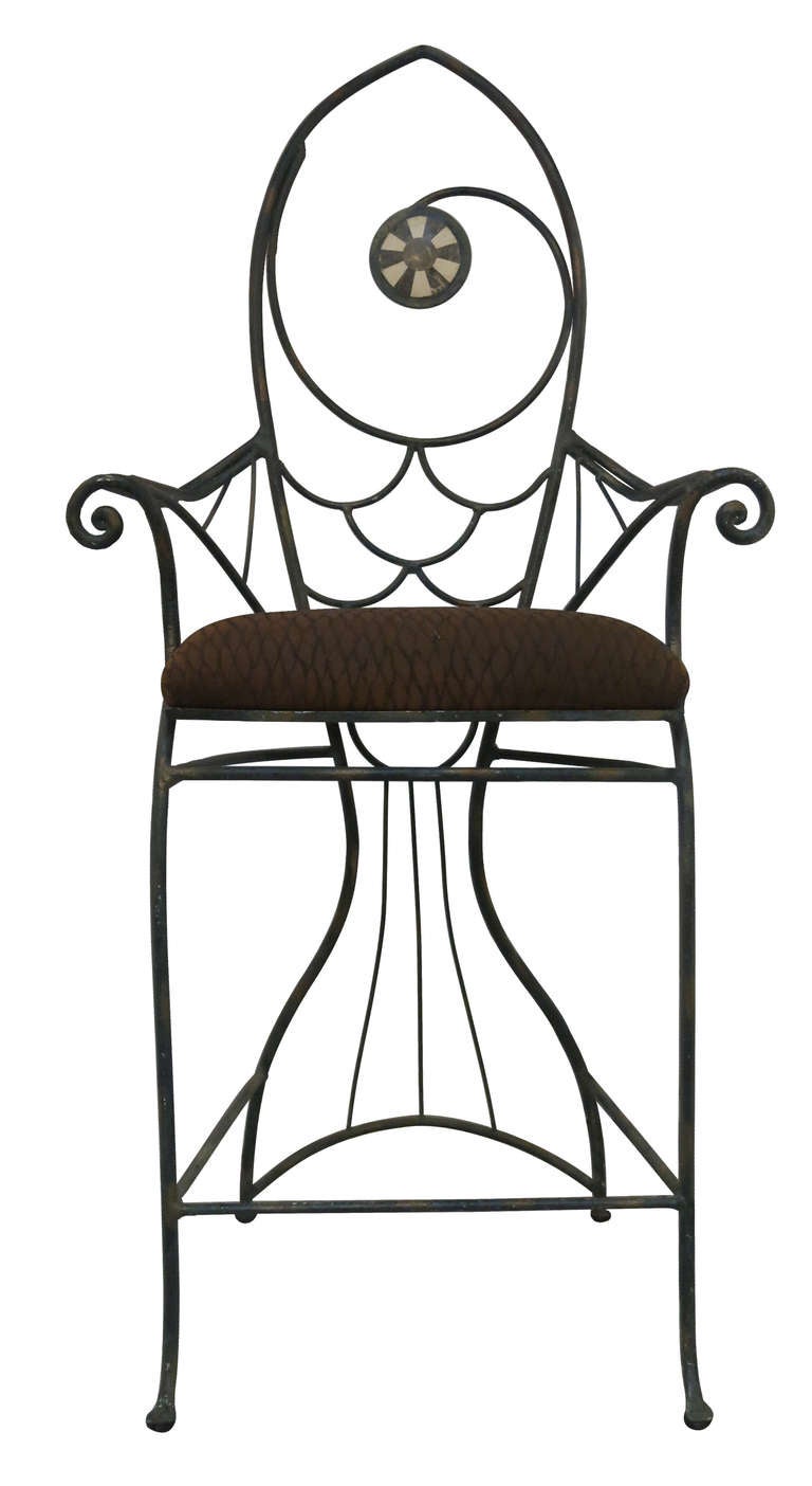 A Pair of whimsical wrought iron and tasseled stone fish bar chairs.