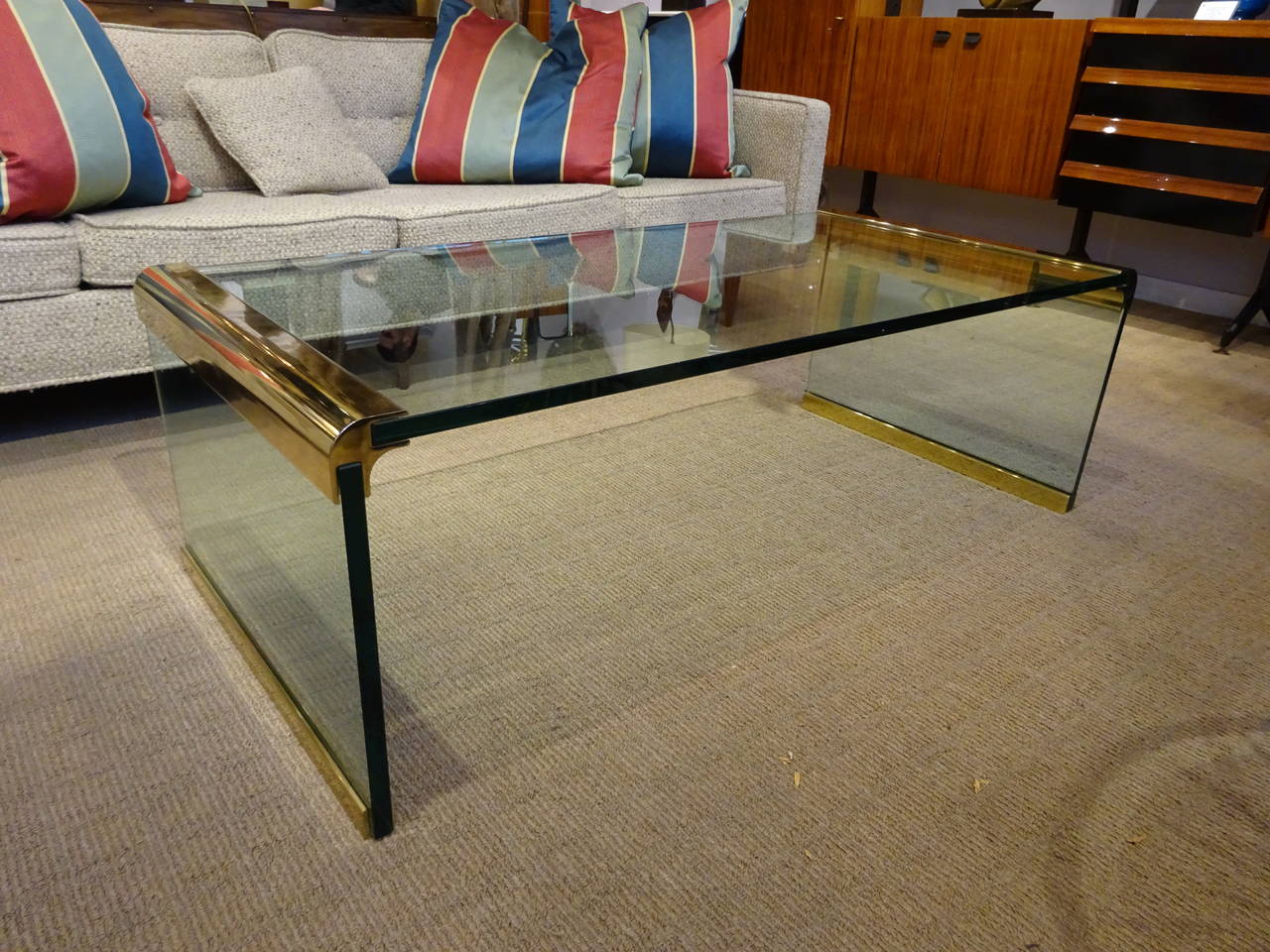 A glass and brass coffee table by Leon Rosen for Pace Collection.