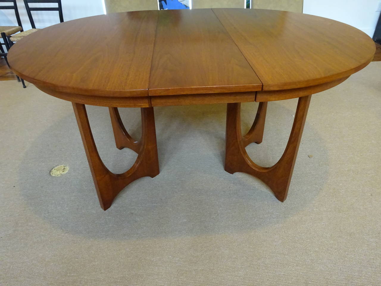 A handsome Harvery Probber style walnut dining room table with two 23.75