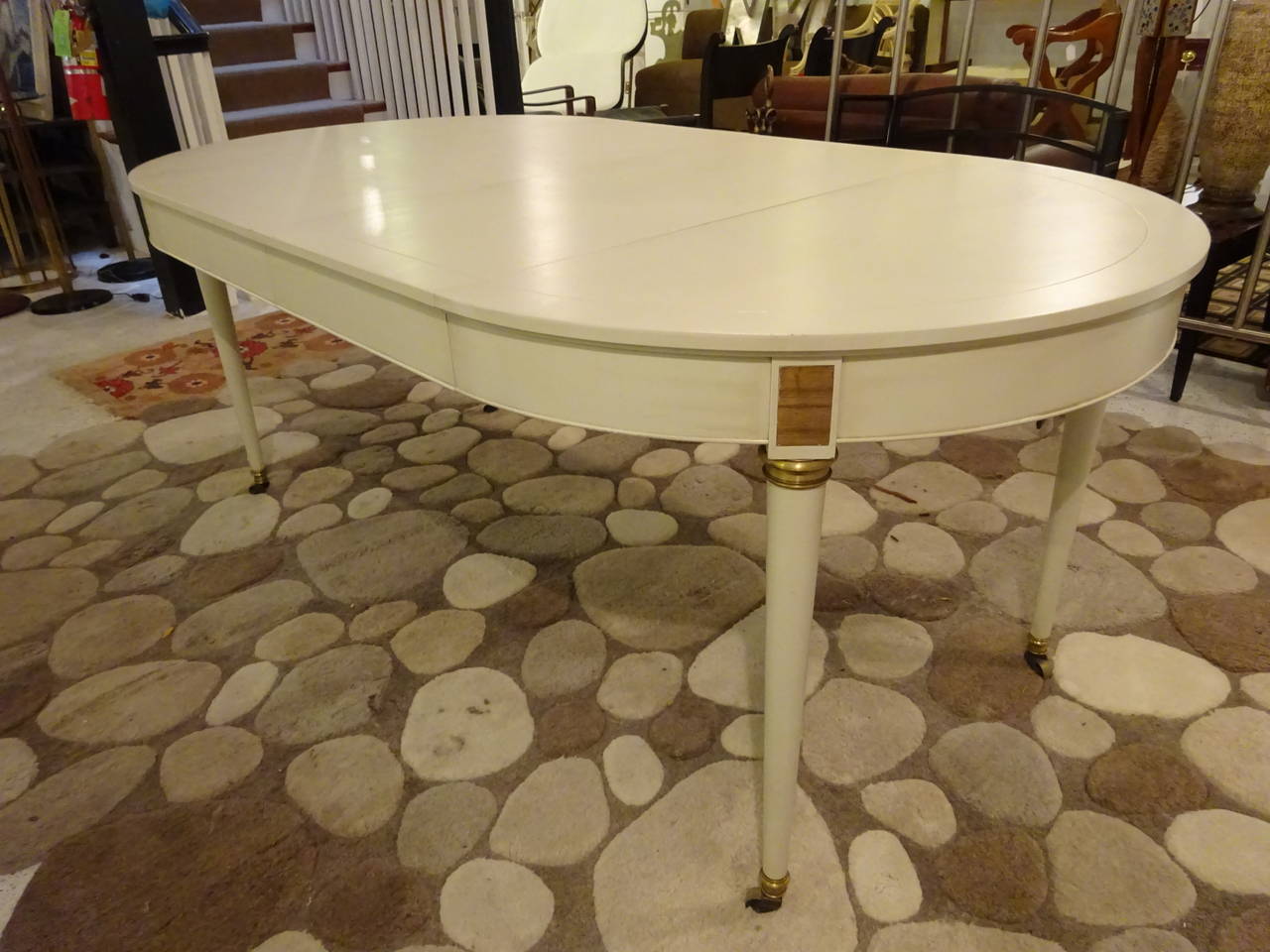 A French Louis XVI style white painted dining room table with two boards. Reduces from round table to oval. Fabulous proportions. 38
