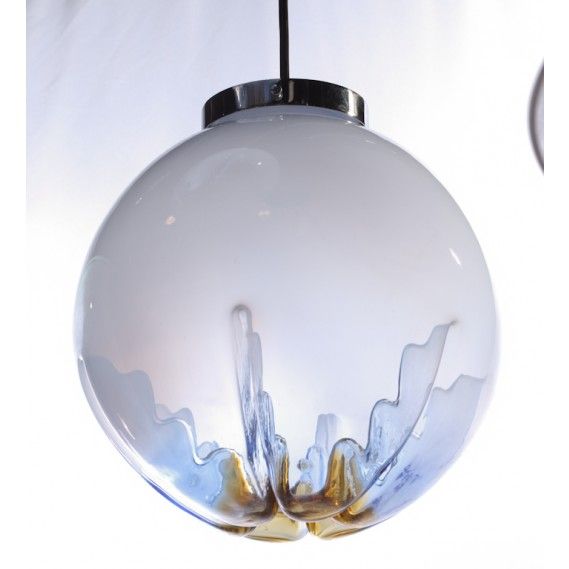 A wonderful and sculptural Italian hand blown glass globe pendant light fixture, circa 1970. Made in Murano, Italy. One of two pendants available. The glass shade is opaque white at the top and becomes clear at the bottom with an amber spot at the