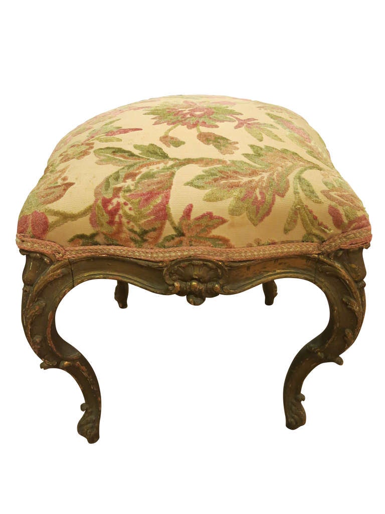 A Louis XVI style taboret painted with a distressed finish and upholstered in a leaf print fabric. France, circa 1900.