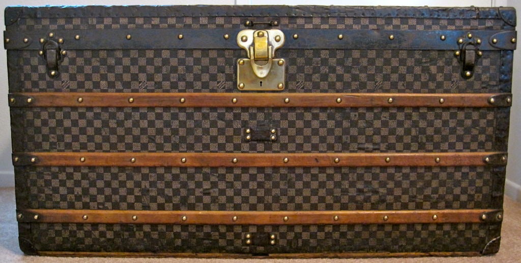 This authentic Louis Vuitton trunk features the deep red/white checker Damier color scheme, which is more rare and desirable than the light brown/dark brown checker Damier color scheme.  <br />
<br />
Age: <br />
Louis Vuitton began producing the
