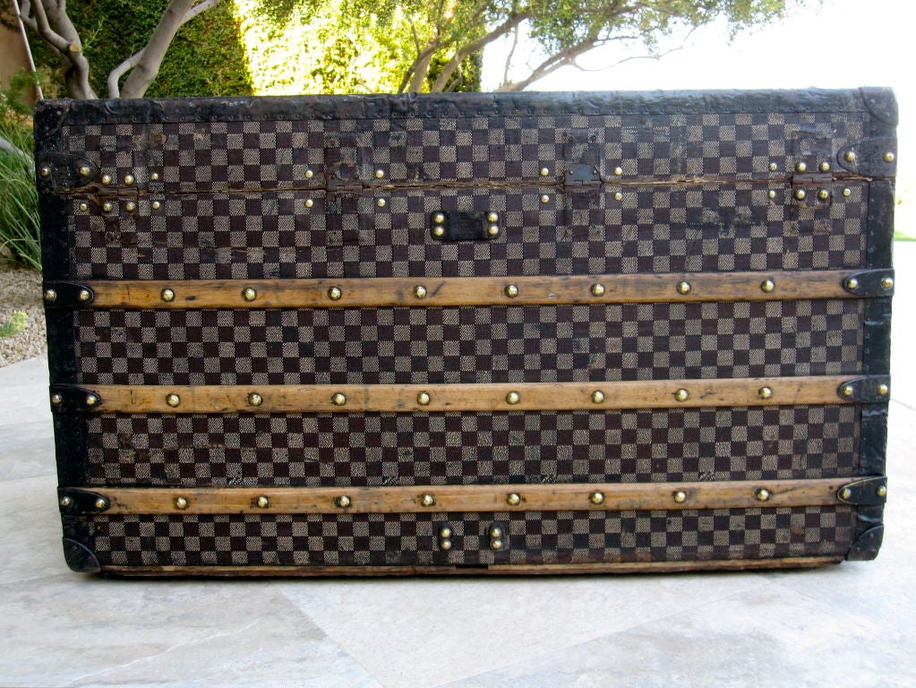 Description: 
This authentic Louis Vuitton trunk features the deep red/white checker Damier color scheme, which is more rare and desirable than the light brown/dark brown checker Damier color scheme.  

Age: 
Louis Vuitton began producing the
