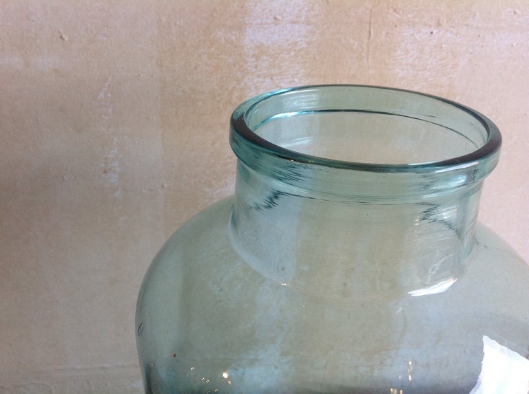 This handblown glass jar, from an Italian food market, was used in the 1940s. The glass has a slightly green tint, and beautiful details resulting from the handblown glassmaking. This jar is marked 5L on the bottom, indicating the size of the jar.