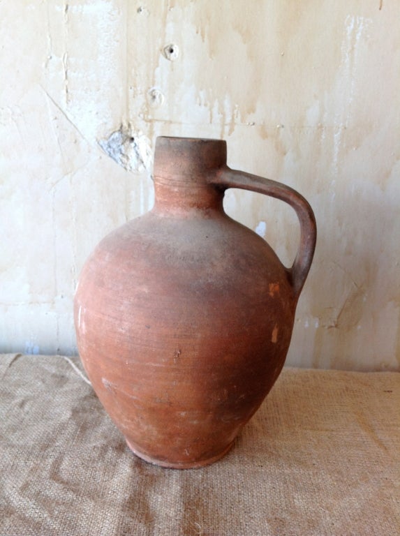 This water jug from calabria was hand crafted in the 19th century.  The rustic finish and charming shape lend this pottery a unique look.