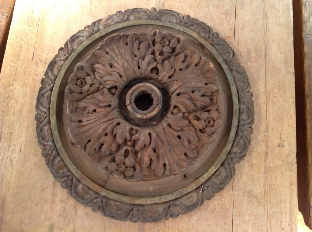 This beautifully carved walnut ceiling medallion comes from a palazzo in Tuscany.  Gold leaf detailing accents the rim.  3 are available, each of which varies slightly.