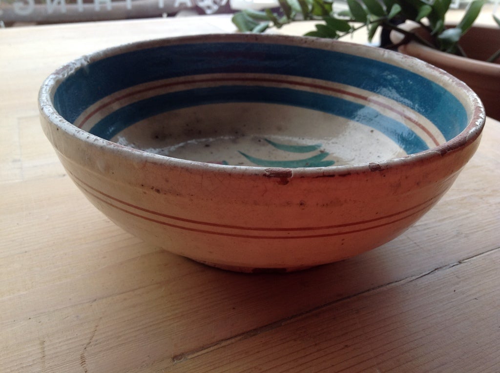 This is a charming antique bowl from Puglia, in the south of Italy.  This is a traditional shape, glazed using several colors, which is less commonly seen.  Some chips and wear to the glaze add charm to this 19th century bowl. Decorative use only.