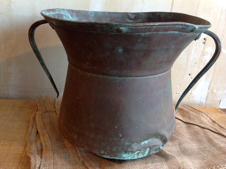 This is a wonderful copper water pot from Italy.  The pot was used to transport water on top of the head.  The patina on the copper is beautiful.  There is a small crack in the pot as well as denting from years of  use. 