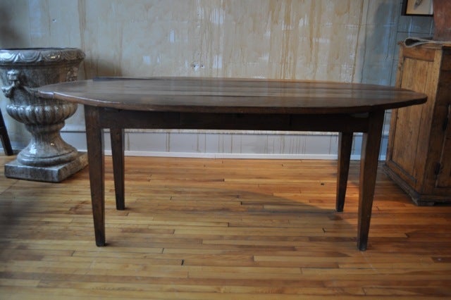 Antique Spanish table. Oval shape with drop-down leaves. Small drawer on front side.