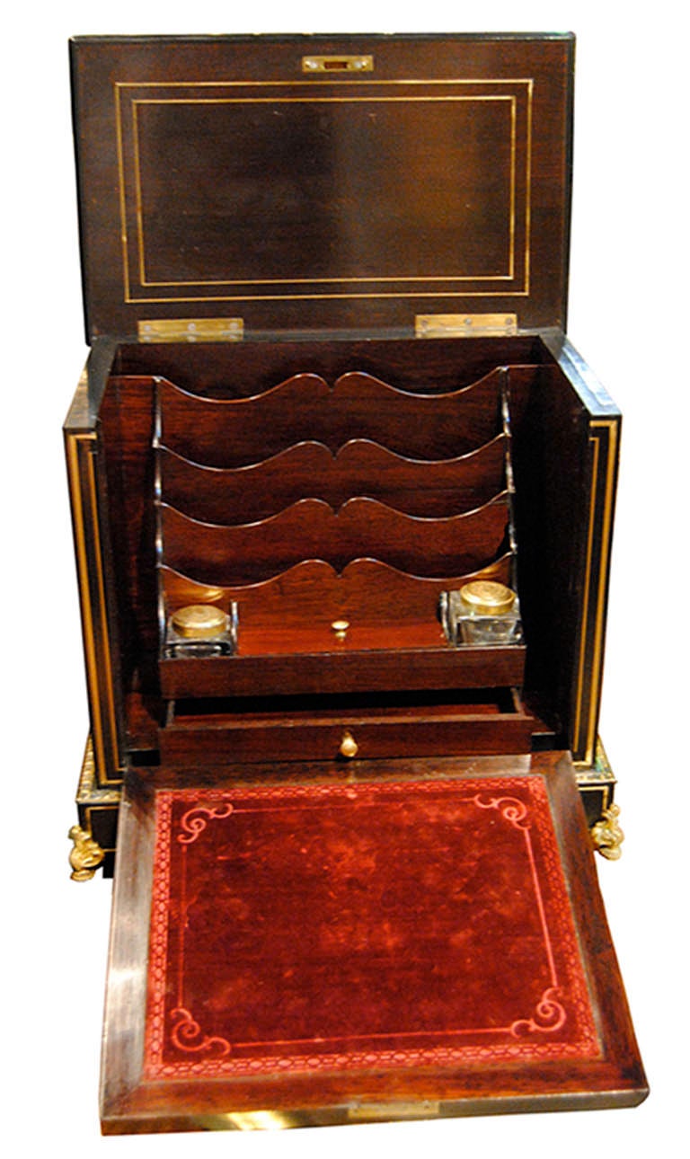19th Century French Boullework letter box with lower right side drawer, the front door opens with key to reveal four stationary slots, two glass ink pots with engraved gold lids, and a red velvet writing surface. Interior also has small drawer and