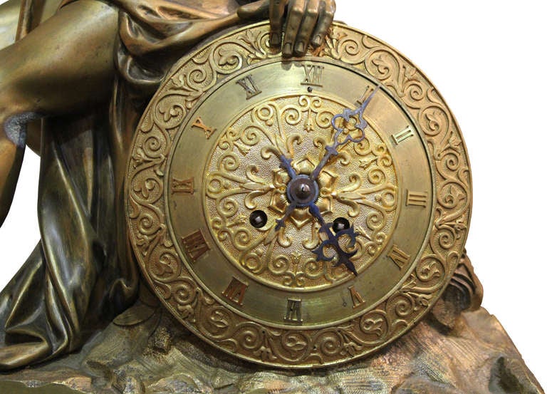 A 19th century Italian empire neoclassical bronze ormolu and Rosso Antico marble mantel clock, displaying a Grecian warrior from the military city-state of Sparta and utilizing his shield as the face of the clock, all raised on a stepped and marble