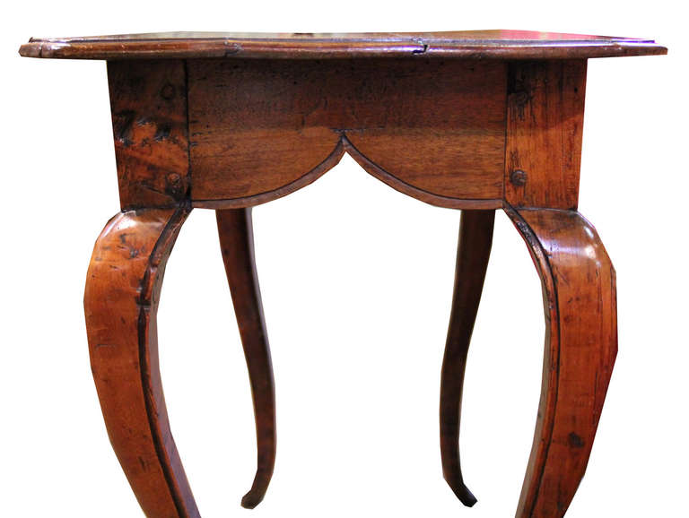 An 18th Century Louis XV Italian Walnut Side Table, the rectangular top with front canted corners and raised on cabriole legs