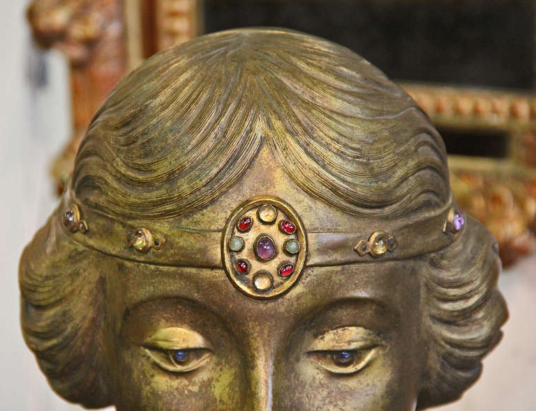 An English Art Nouveau bust of the royal Princess Mary, countess of harewood, the third child and only daughter of King George V and Queen Mary, cast in a bronze alloy and plated in brass (now worn), expertly draped in marble garb, with exquisite