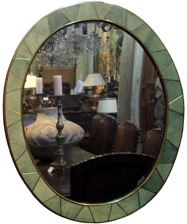 A 20th Century Shagreen Oval Mirror, the celadon shagreen in triangular forms creating the perimeter and outlined with aged brass banding and mirror retaining the original plate