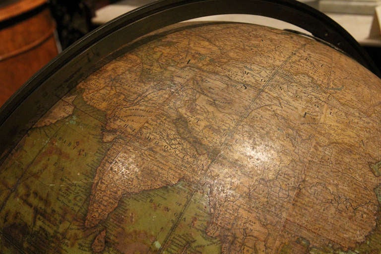 The globe is marked and signed by W. A&K JOHNSTONS. It reads, "An Eighteen Inch Terrestrial Globe containing the latest Geographical Disrobrries, 1873. W. A&K Johnstons, Geographers and Engravers to the Queen." Amongst the