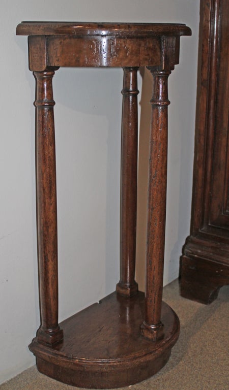 A Diminutive Pair of 18th c. Tuscan Walnut Demilune Consoles / Side Tables, each with three neoclassical columns raised on a plinth base, perfect for small walls flanking a door or to accompany a chair, bench or sofa; these are two from a set of