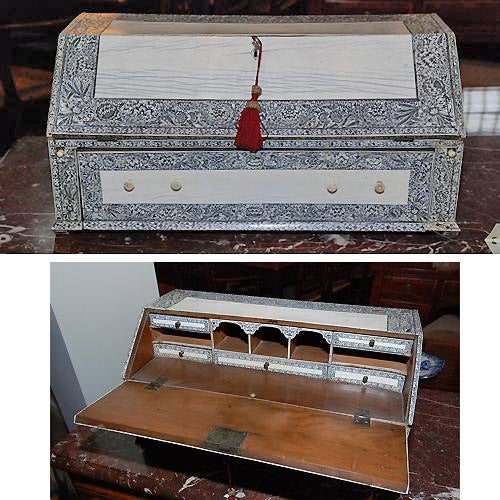 An intricate 19th century English Anglo-Indian Vizagapatam lac-engraved bone jewelry and tabletop box, in the form of a slant front desk, opening to reveal a writing surface supported by retractable lopers, multiple conforming drawers and cubbies,