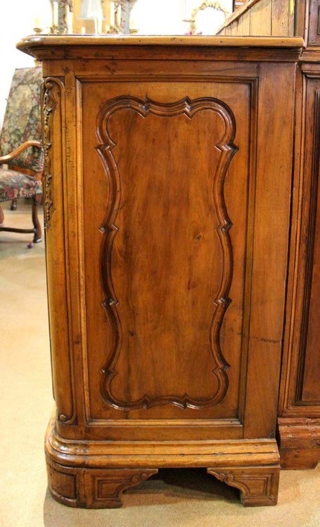 An 18th c. Northern Italian Walnut Credenza, from Reggio Emilia, a town located in the Emilia Romagna area of Italy, with three upper drawers above three cabinet doors, carved with shaped and fielded panels and with high relief trailing husks