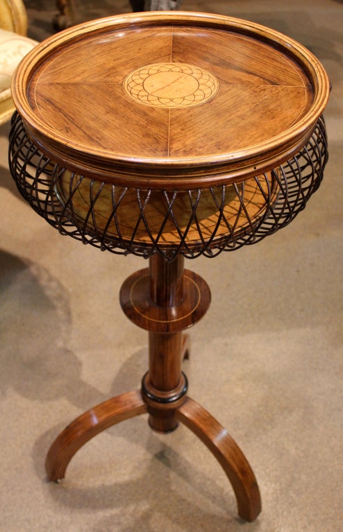 An unusual and Whimsical 19th century Charles X walnut, satinwood, and ebony parquetry side table, originally used as a sewing and worktable, with wooden "wire" basket, with the top inlaid with a basket motif of exotic wood, opening to