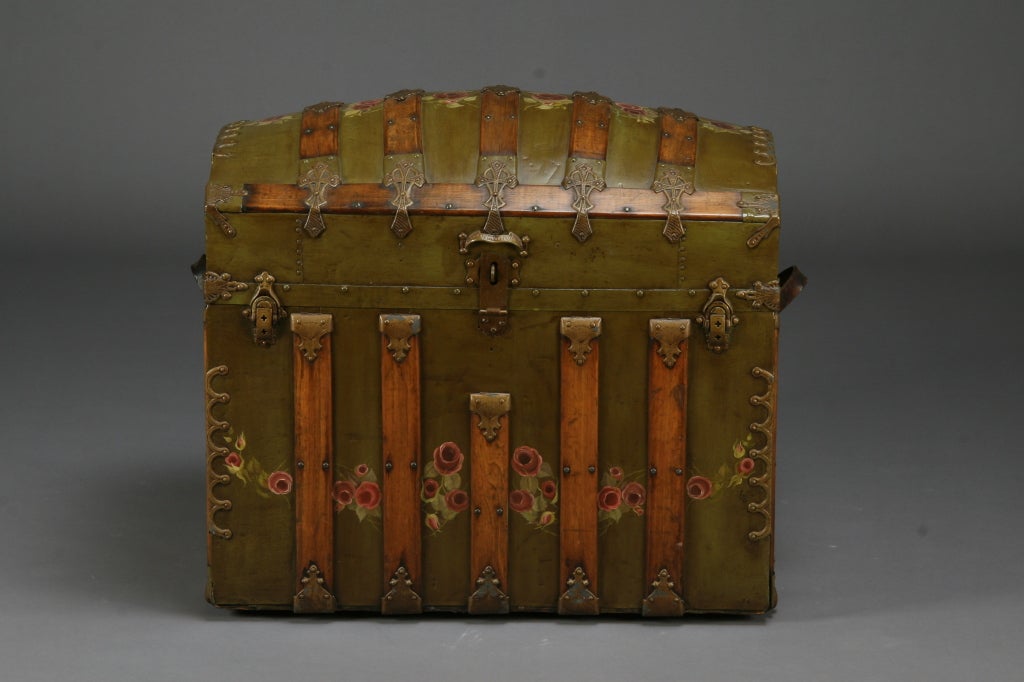 19th century dome top European trunk decorated with handpainted roses, the interior lined with fabric and a painted portrait of a young girl - its original owner.