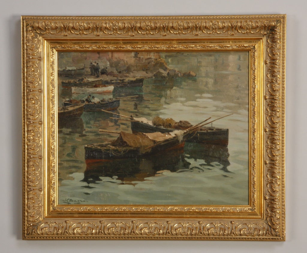 Early 20th century oil on panel depicting working fishing boats anchored along the coast, signed lower left, L. G. (Leon Giuseppe) Buono, (Italian 1888-1975).
