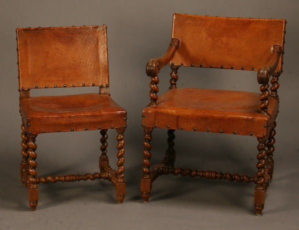 Set of six 19th century Jacobean-style chairs upholstered in leather with nailhead trim, supported by carved oak barley twist legs joined by a similarly carved H-shaped stretcher base, includes 2 arm chairs (34