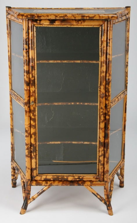 Fine early 20th century English bamboo curio cabinet with canted sides and applied decorations.