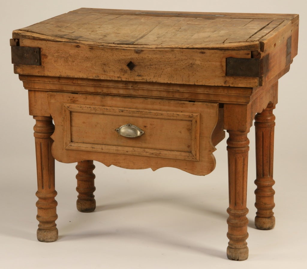 Late 19th century French oak butcher block table with knife holder and storage drawer.