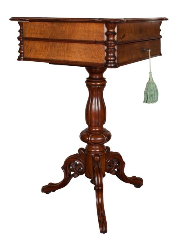 An English burl walnut work table with fitted original interior and ivory knobs with keyed top drawer that locks the top down ending a turned tripod base, finished all sides, original restored finish

A sewing table or work table is a table or