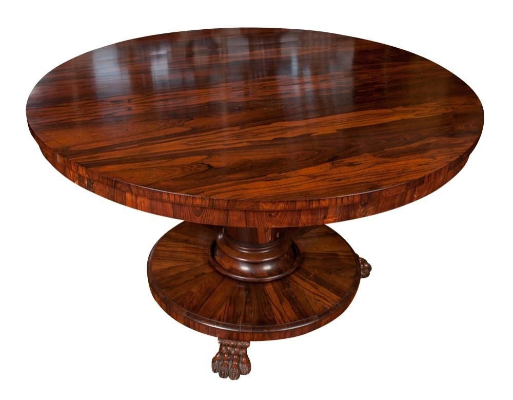 Originally $ 14,000.00

PLEASE VISIT OUR SITE FOR ADDITIONAL SPECIALS

A Regency period English Tilt-Top center table made of RARE rosewood raised on a central pedestal having beautifully carved, shaped base ending on intricately carved lion's