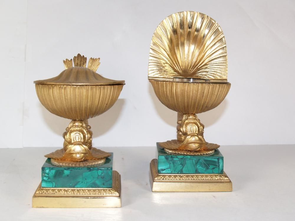 PAIR OF NEO-CLASSICAL STYLE ORMOLU & MALACHITE
INKWELLS, SIGNED TIFFANY ON BASE, EACH LIDDED WELL IN THE FORM OF A SHELL, ON A BASE COMPOSED OF A SEA CREATURES ON A MALACHITE PLINTH.

 Malachite is a copper carbonate mineral, with the formula