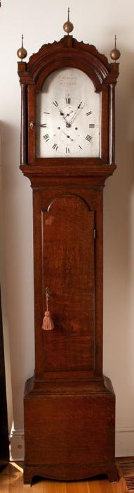 English Oak tall case clock having a  silvered face bearing the makers mark 